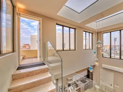 a home with a glass staircase and windows at El Gouna Villa in Tawila with private pool in Hurghada