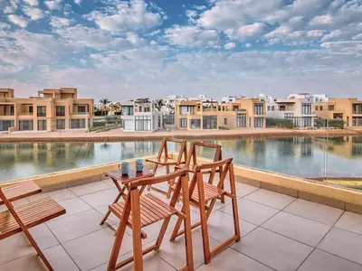 a patio with two chairs and a table on a balcony at El Gouna Villa in Tawila with private pool in Hurghada