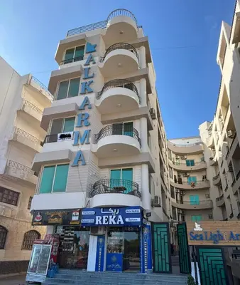 a tall building with a sign in front of it at Arabia Sea View in Hurghada