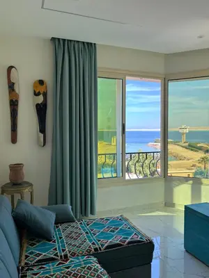 a living room with a view of the ocean at Arabia Sea View in Hurghada