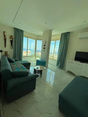 a living room with a couch and a table at Arabia Sea View in Hurghada