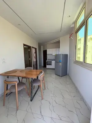 a kitchen with a table and chairs and a refrigerator at Arabia Sea View in Hurghada