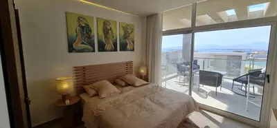 a bedroom with a bed and a large window at The dune Terrace in Hurghada
