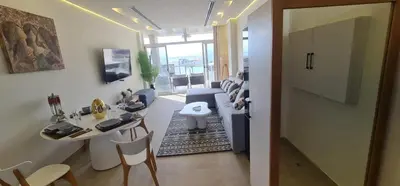 a living room with a couch and a table and chairs at The dune Terrace in Hurghada