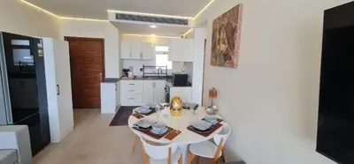 a kitchen and dining room with a white table and chairs at The dune Terrace in Hurghada