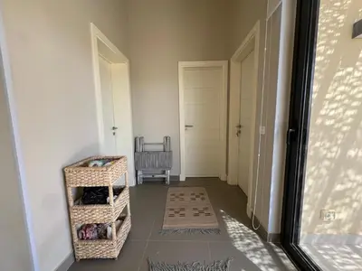 a hallway with a door and a chair in a room at Tawila Luxury 2BR Skyline Loft • Rooftop in Hurghada