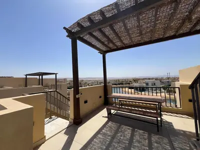a balcony with a bench on top of a building at Tawila Luxury 2BR Skyline Loft • Rooftop in Hurghada