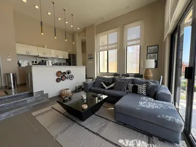 a living room with a couch and a table at Tawila Luxury 2BR Skyline Loft • Rooftop in Hurghada