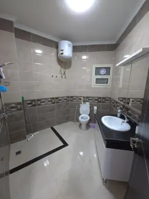 a bathroom with a toilet and a sink at Zafira Apartman in Hurghada