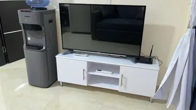 a entertainment center with a tv and a entertainment system at Zafira Apartman in Hurghada