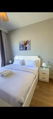 a bedroom with a large bed with white sheets and pillows at Luxury villa in Hurghada