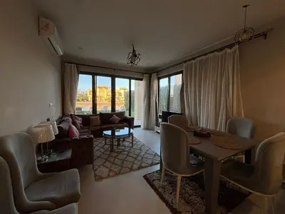 a living room with a table and chairs at Apartment in El gouna mangrouovy in Hurghada