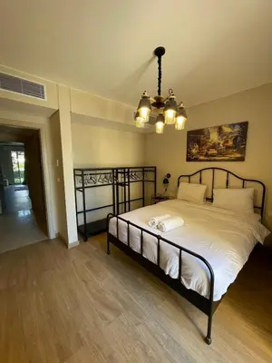 a bedroom with a large bed with a chandelier at Apartment in El gouna mangrouovy in Hurghada
