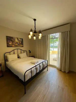 a bedroom with a bed and a large window at Apartment in El gouna mangrouovy in Hurghada