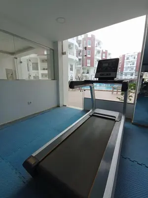 a treadmill in a room with a window and a desk at 2 bed Flat, Hurghada, long&short in Hurghada