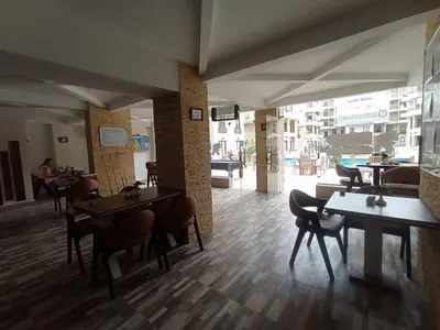 a restaurant with tables and chairs in a room at 2 bed Flat, Hurghada, long&short in Hurghada
