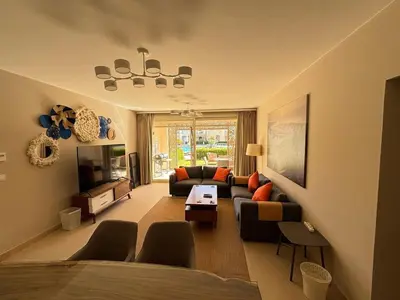 a living room with a couch and a tv at Apartment in front of the beach in Hurghada