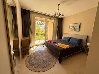 a bedroom with a bed and a large window at Apartment in front of the beach in Hurghada