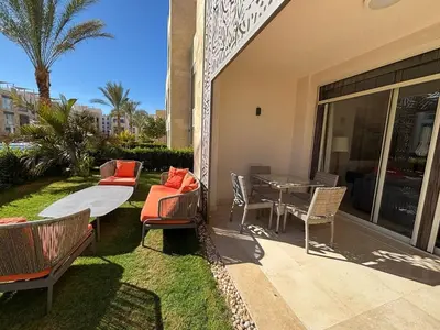 a patio with a table and chairs and a table at Apartment in front of the beach in Hurghada