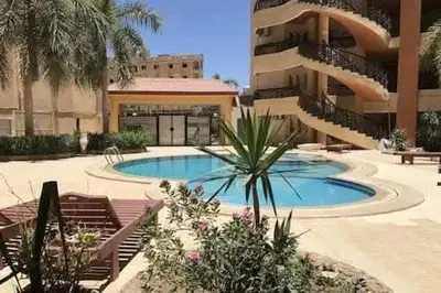 a courtyard with a swimming pool in a building at Regency towers résidence in Hurghada