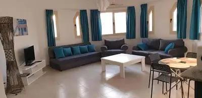a living room with a couch and a table at Regency towers résidence in Hurghada