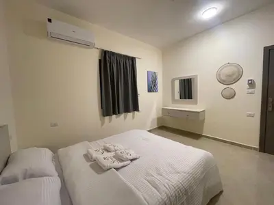 a bedroom with two beds with towels on them at Bayt Hassan S18 - Fabulous Roof top 1 bedroom apartment in Hurghada