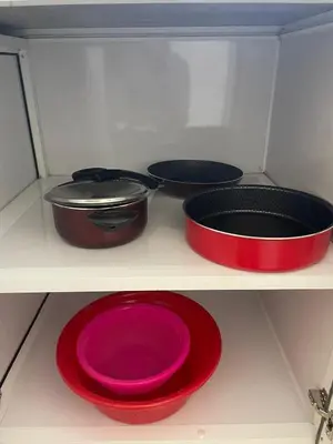 four pots and pans on a shelf in a kitchen at Bayt Hassan S18 - Fabulous Roof top 1 bedroom apartment in Hurghada