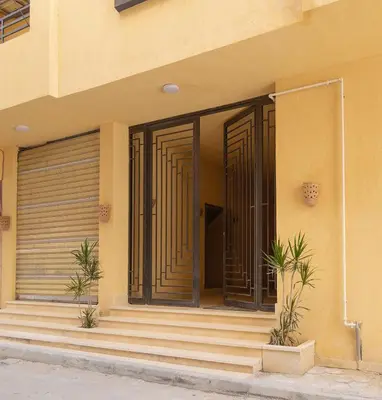 a front door of a building with stairs at Bayt Hassan S18 - Fabulous Roof top 1 bedroom apartment in Hurghada