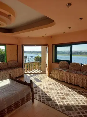 a bedroom with two beds and a view of the water at Downtown apartment in Luxor
