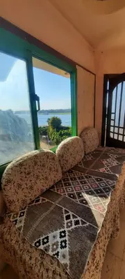a room with a table and a large window at Downtown apartment in Luxor