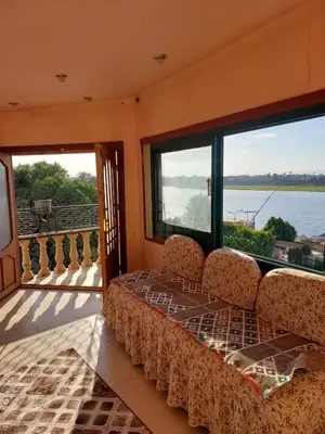 a bed in a room with a view of the water at Downtown apartment in Luxor
