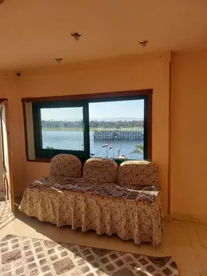 a room with two chairs and a large window at Downtown apartment in Luxor