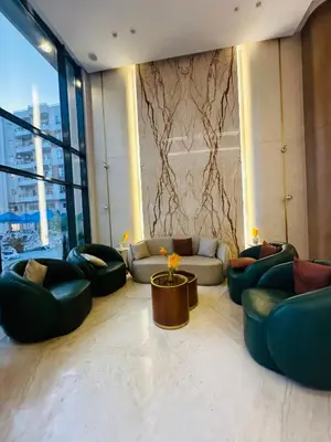 a living room with couches and chairs in a building at Unique Studio Free access beach in Hurghada