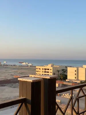 a view of the ocean from the balcony of a building at Unique Studio Free access beach in Hurghada