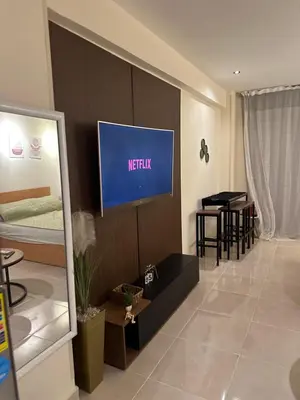 a living room with a television on a wall at Unique Studio Free access beach in Hurghada