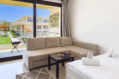 a living room with a couch and a table at The Softline Studio G-Cribs in Hurghada