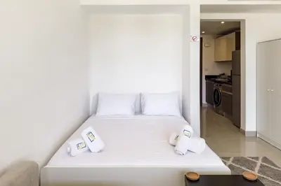 a white bed with two pillows on it in a room at The Softline Studio G-Cribs in Hurghada
