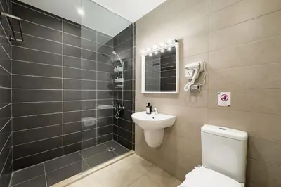 a bathroom with a toilet and a sink and a shower at The Softline Studio G-Cribs in Hurghada
