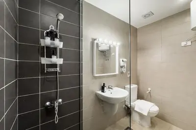a bathroom with a toilet and a sink and a shower at The Softline Studio G-Cribs in Hurghada