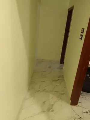 a hallway with a marble floor in a room at Neu Student Home in Jazīrat Aswān