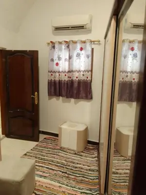 a room with a door and a window and a rug at Neu Student Home in Jazīrat Aswān