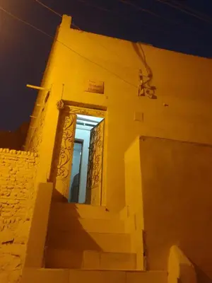 a door on a building with stairs at night at Neu Student Home in Jazīrat Aswān