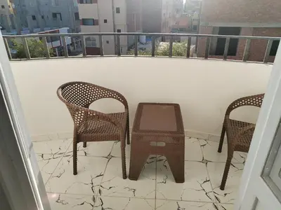 two chairs and a table on a balcony at Dream House in Hurghada