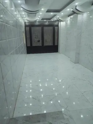 an empty room with white marble floors and doors at Dream House in Hurghada