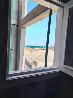 a window with a view of the beach at Dream House in Hurghada