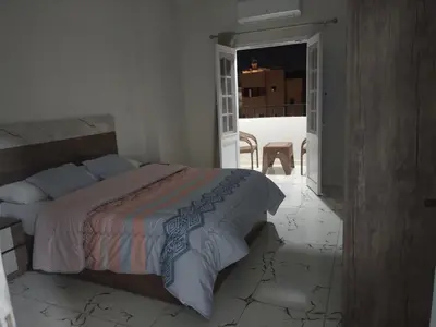 a bedroom with a bed in a room with a window at Dream House in Hurghada