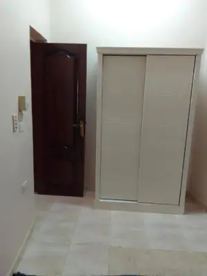 a white closet with a glass door in a room at Neu Student Home 2 in Jazīrat Aswān