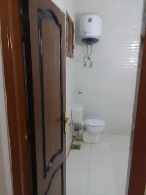 an open door to a bathroom with a toilet at Neu Student Home 2 in Jazīrat Aswān