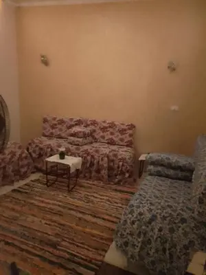 a living room with a couch and a table at Neu Student Home 2 in Jazīrat Aswān