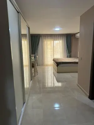 a bedroom with a bed and a large mirror at Apartment with private beach 09D in Hurghada